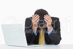 Frustrated businessman with laptop