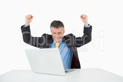 Man being victorious at his desk