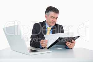Man reading documents on his desk
