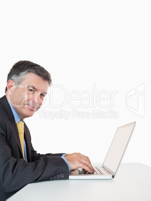 Happy man typing on laptop