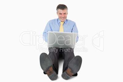 Happy businessman working on the floor