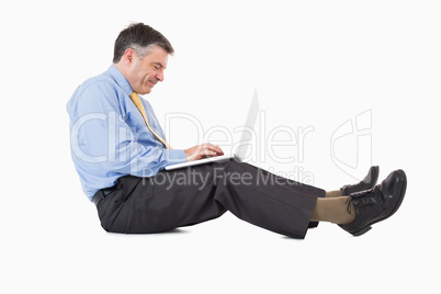 Man working on laptop on the floor