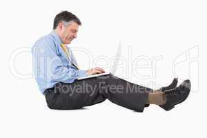 Man working on laptop on the floor
