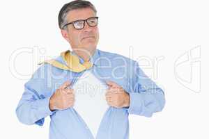Serious man with glasses is pulling his shirt with his hands