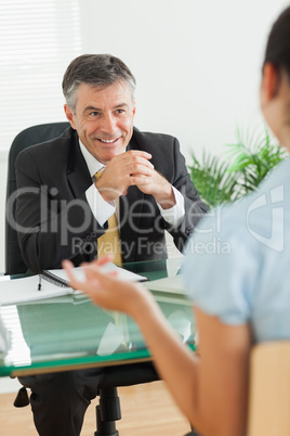 Businessman laughing with a woman in his office