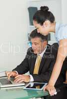 Business man and woman working on a laptop