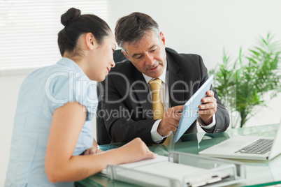 Business man explaining something with digital tablet