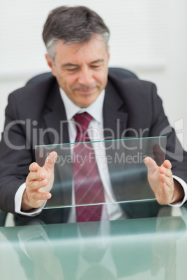 Smiling business man holding a virtual screen