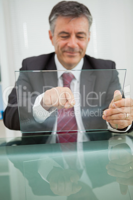 Smiling man touching on a virtual screen