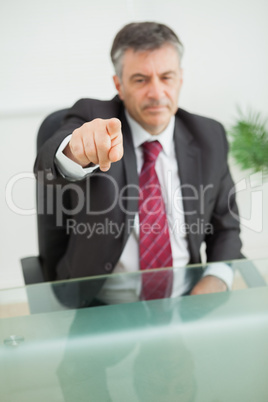 Serious businessman pointing