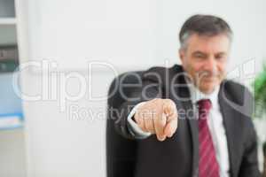 Smiling businessman pointing