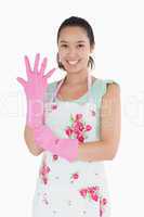 Woman putting on plastic gloves