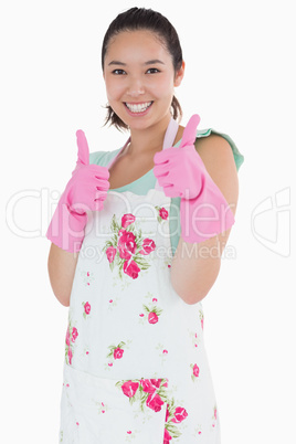 Woman wearing rubber gloves giving thumbs up