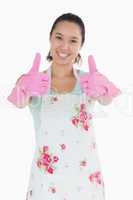 Happy woman in rubber gloves giving thumbs up