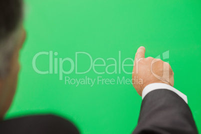 Businessman pointing to green copy space