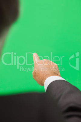 Man pointing to green copy space