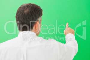 Man pointing on a green screen