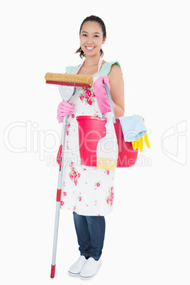 Woman holding some cleaning tools