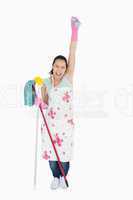 Woman holding a sponge in the air and shouting