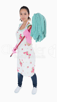 Woman holding a mop in the air