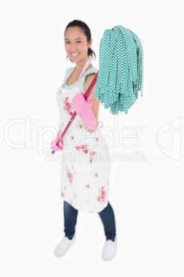 Woman holding a mop with gloves on