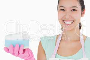 Smiling woman with a sponge