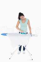 Brunette ironing shirts