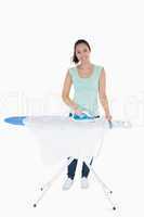 Happy woman doing the ironing