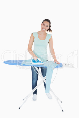 Smiling woman ironing jumper