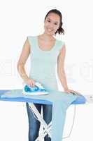 Woman happily doing the ironing