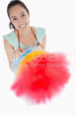 Happy woman holding a duster
