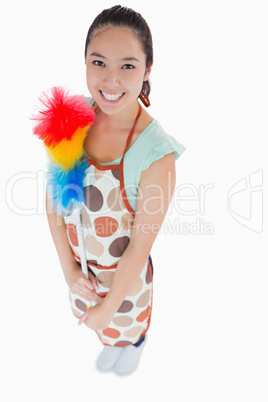 Happy woman holding duster