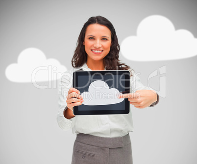 Businesswoman holding a tablet pc showing cloud symbol