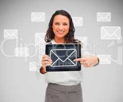 Businesswoman pointing to mail symbol on tablet pc