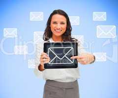 Businesswoman pointing to mail symbol on her digital tablet