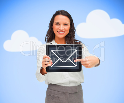 Businesswoman standing holding a tablet computer showing mail sy