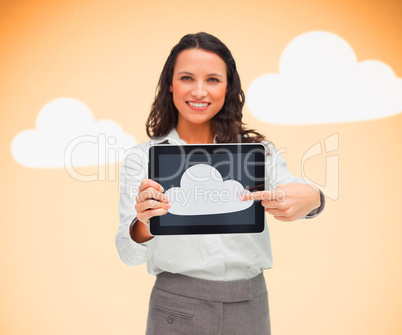Woman standing while holding a tablet pc pointing to cloud symbo