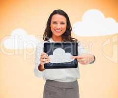 Woman standing while holding a tablet pc pointing to cloud symbo