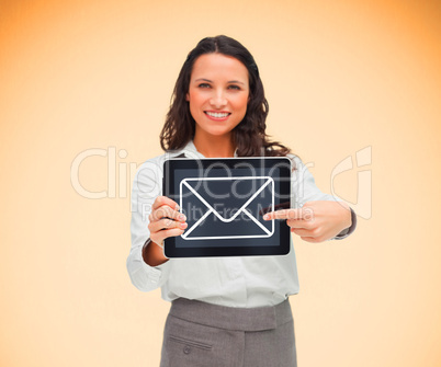 Businesswoman holding a tablet pc smiling and pointing at mail s