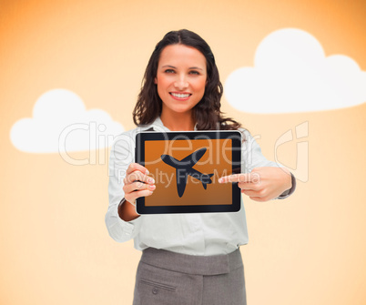 Woman pointing to airplane symbol on tablet pc