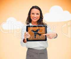 Woman pointing to airplane symbol on tablet pc