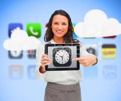 Businesswoman standing holding a tablet pc pointing to clock app