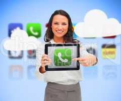 Businesswoman holding a tablet computer while smiling with phone