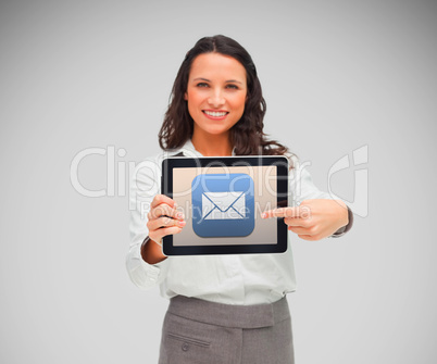 Businesswoman smiling while holding a tablet computer and pointi