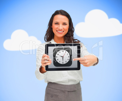 Woman standing while smiling holding a tablet pc