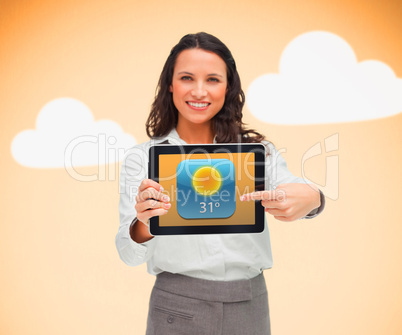 Businesswoman pointing to weather app symbol on tablet