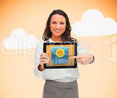 Businesswoman pointing to weather app symbol on tablet