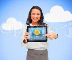 Woman standing holding a tablet pc against blue background point
