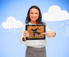 Woman standing holding a tablet pc showing a plane symbol