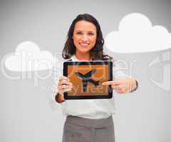 Businesswoman pointing at plane symbol on tablet pc